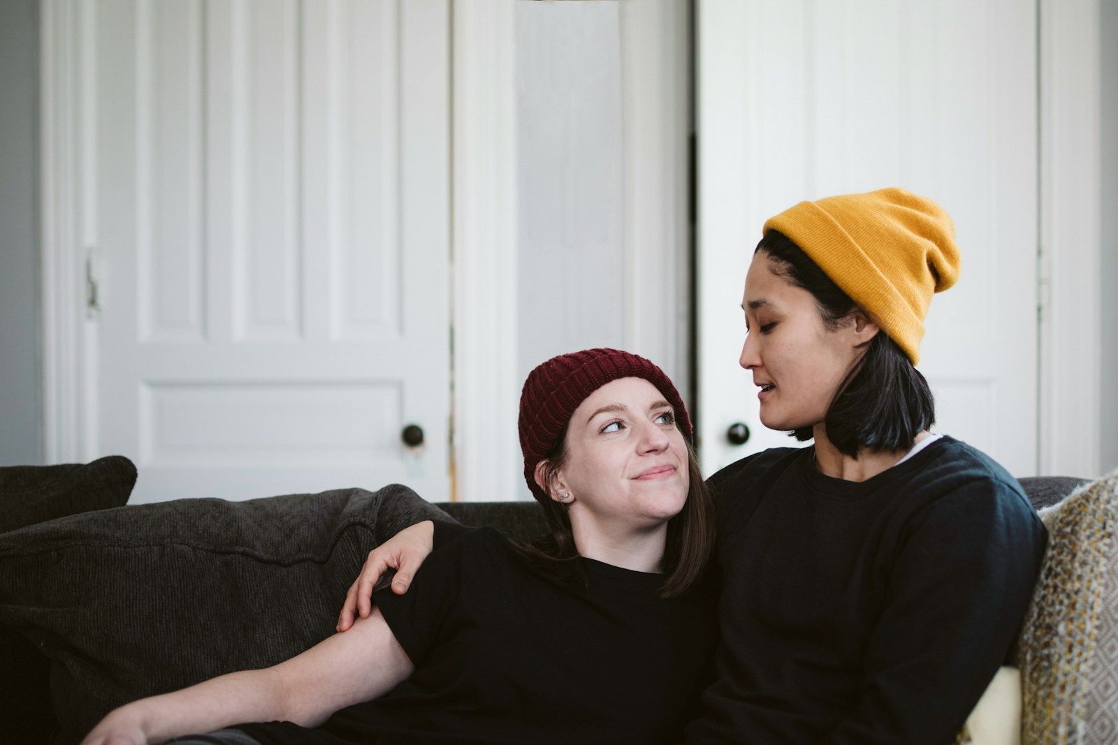 Two people talking on a couch