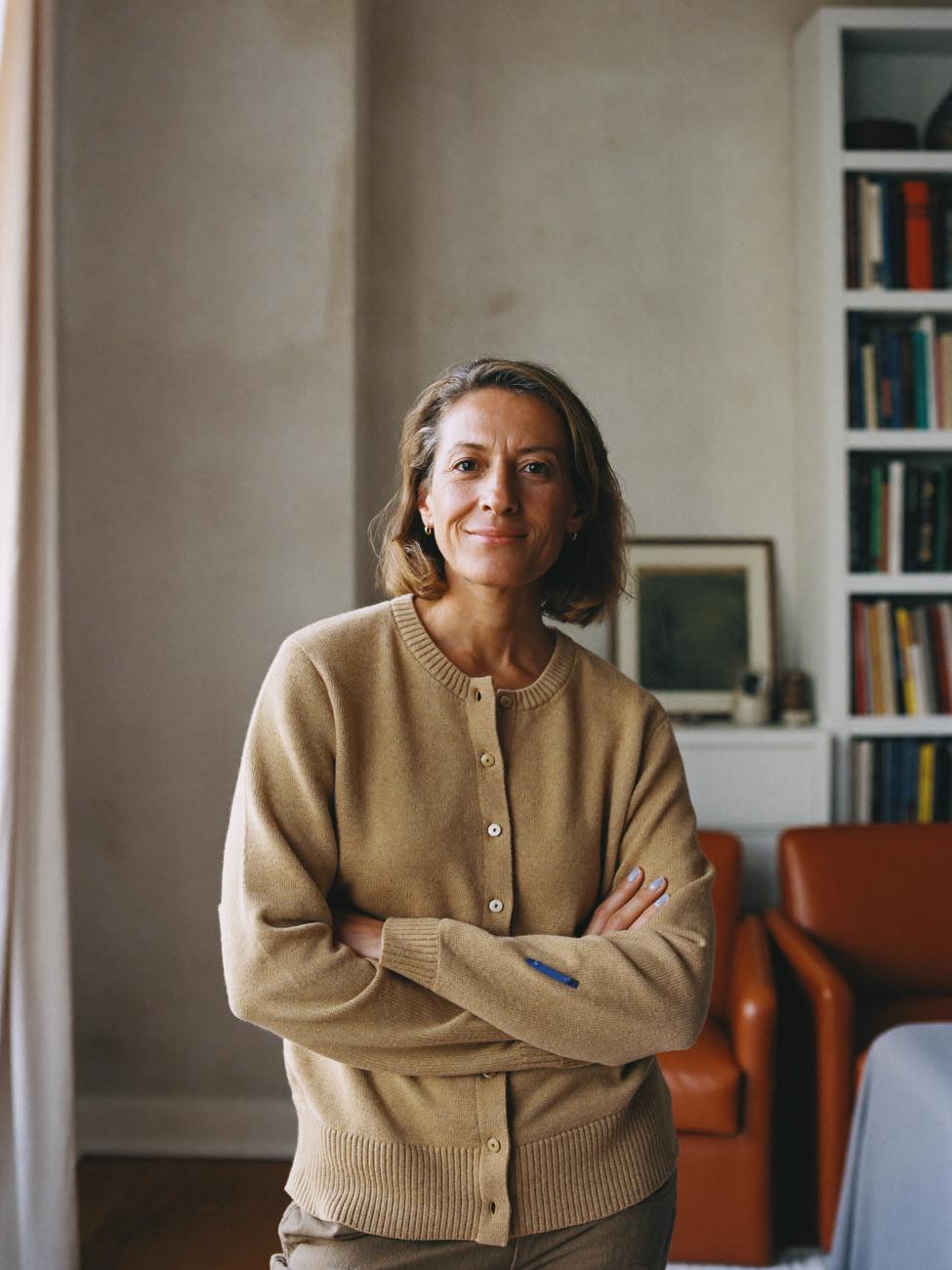 A licensed therapist standing in her sunlit practice
